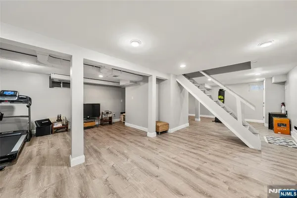 a view of a livingroom with wooden floor and stairs