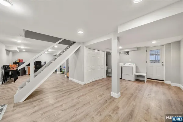 a view of a livingroom with wooden floor and stairs