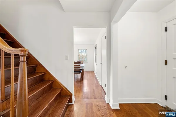 a view of entryway and hall with wooden floor