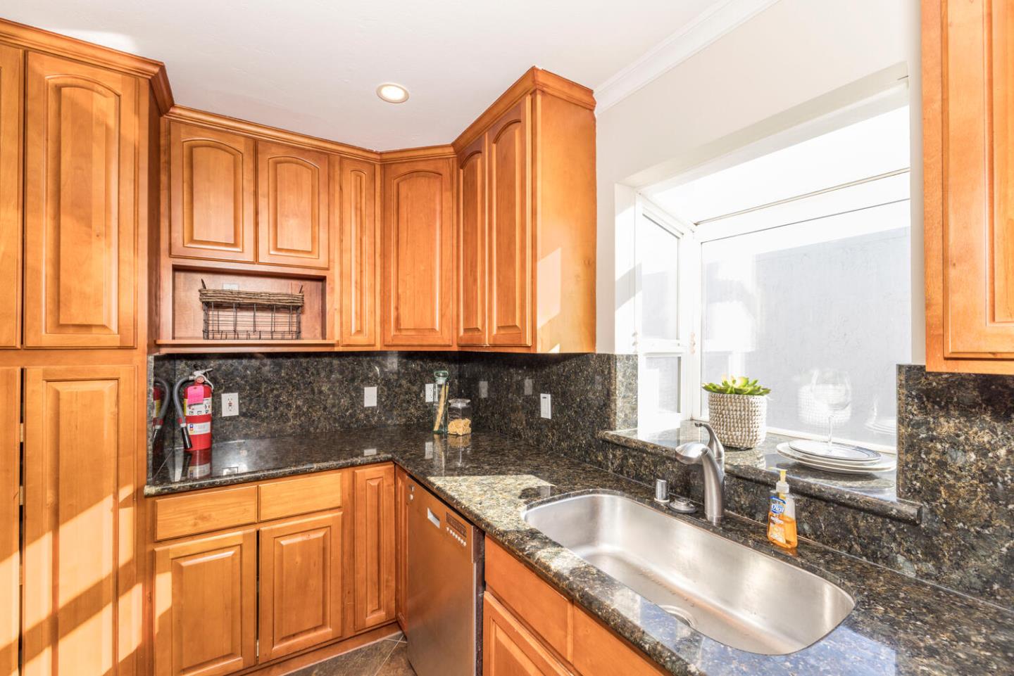 873 Morningside Drive Millbrae, CA 94030 - Photo 11 of 47 a kitchen with granite countertop a sink and a refrigerator
