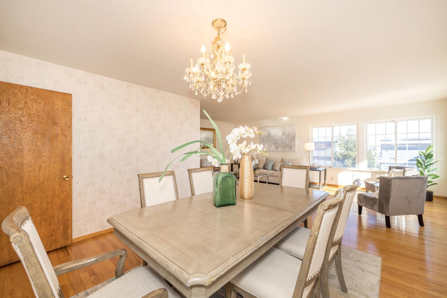 873 Morningside Drive Millbrae, CA 94030 - Photo 15 of 47 a dining room with furniture a chandelier and wooden floor