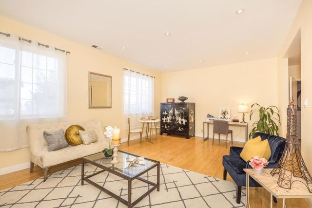 a living room with furniture and a table