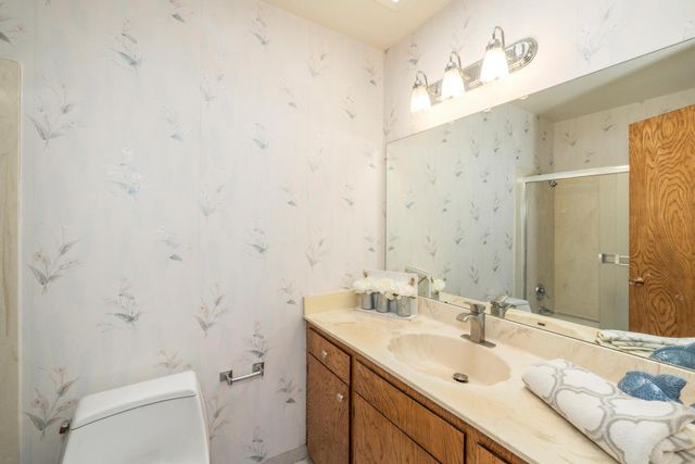 a bathroom with a sink toilet and shower