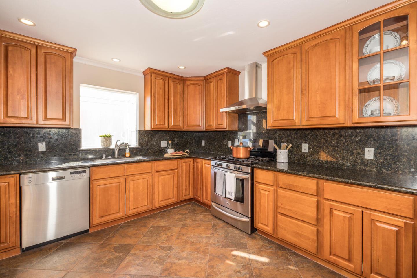 873 Morningside Drive Millbrae, CA 94030 - Photo 9 of 47 a kitchen with stainless steel appliances granite countertop a stove a sink and a microwave
