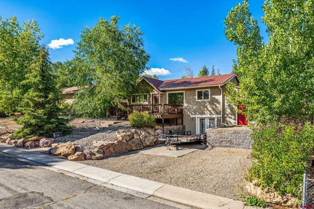 a view of a chair and table in the backyard