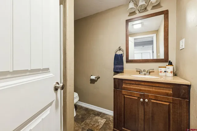 a white toilet sitting next to a bathroom sink