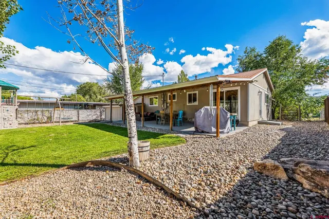 a view of a patio with table and chairs potted plants with wooden floor