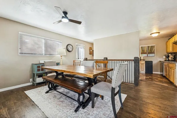 a living room with chairs a piano and a table