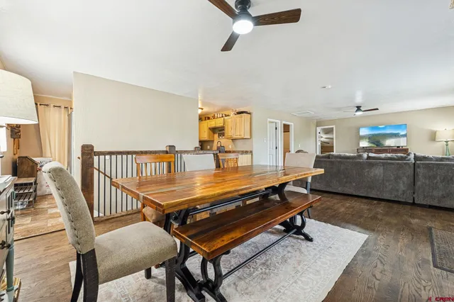 a living room with furniture a rug and a chandelier