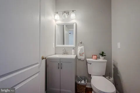 a bathroom with a toilet a sink and mirror