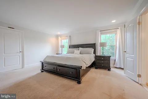 a spacious bedroom with a bed and window