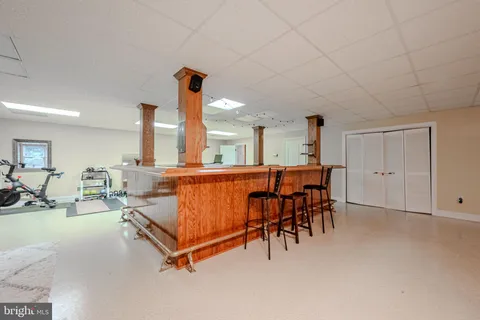 a living room with furniture a table tennis table and a fireplace