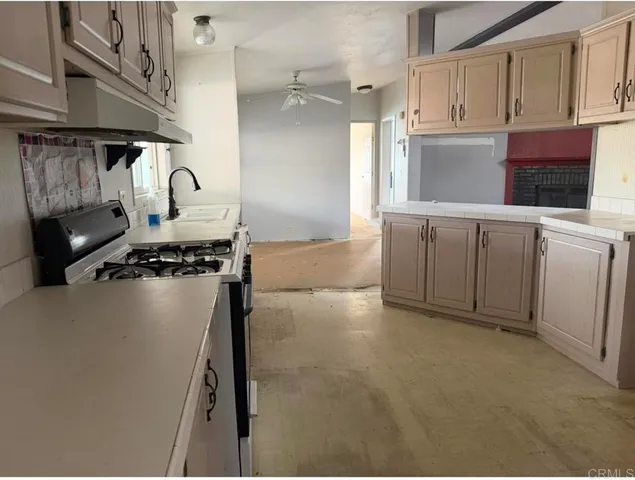 a kitchen with cabinets and appliances