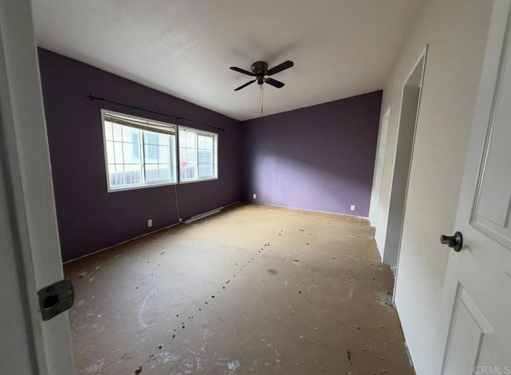 1638 Calavo Road, Unit 63 Fallbrook, CA 92028 - Photo 6 of 9 an empty room with windows and fan