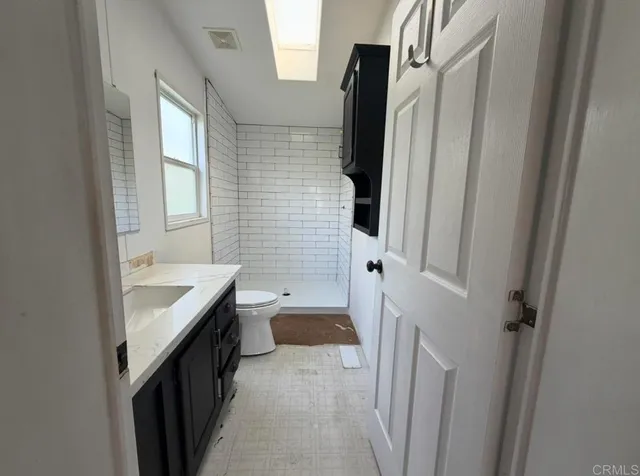 a bathroom with a sink a toilet and a tub