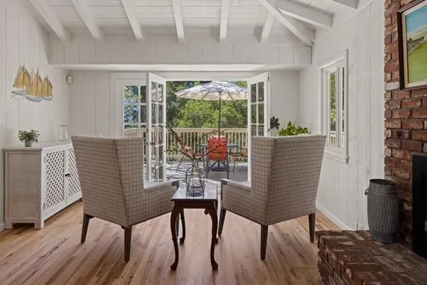 a view of a dining room with furniture window and wooden floor