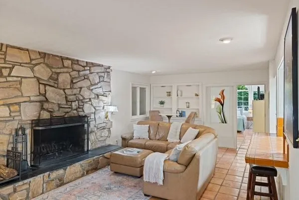 a living room with furniture a flat screen tv and a fireplace