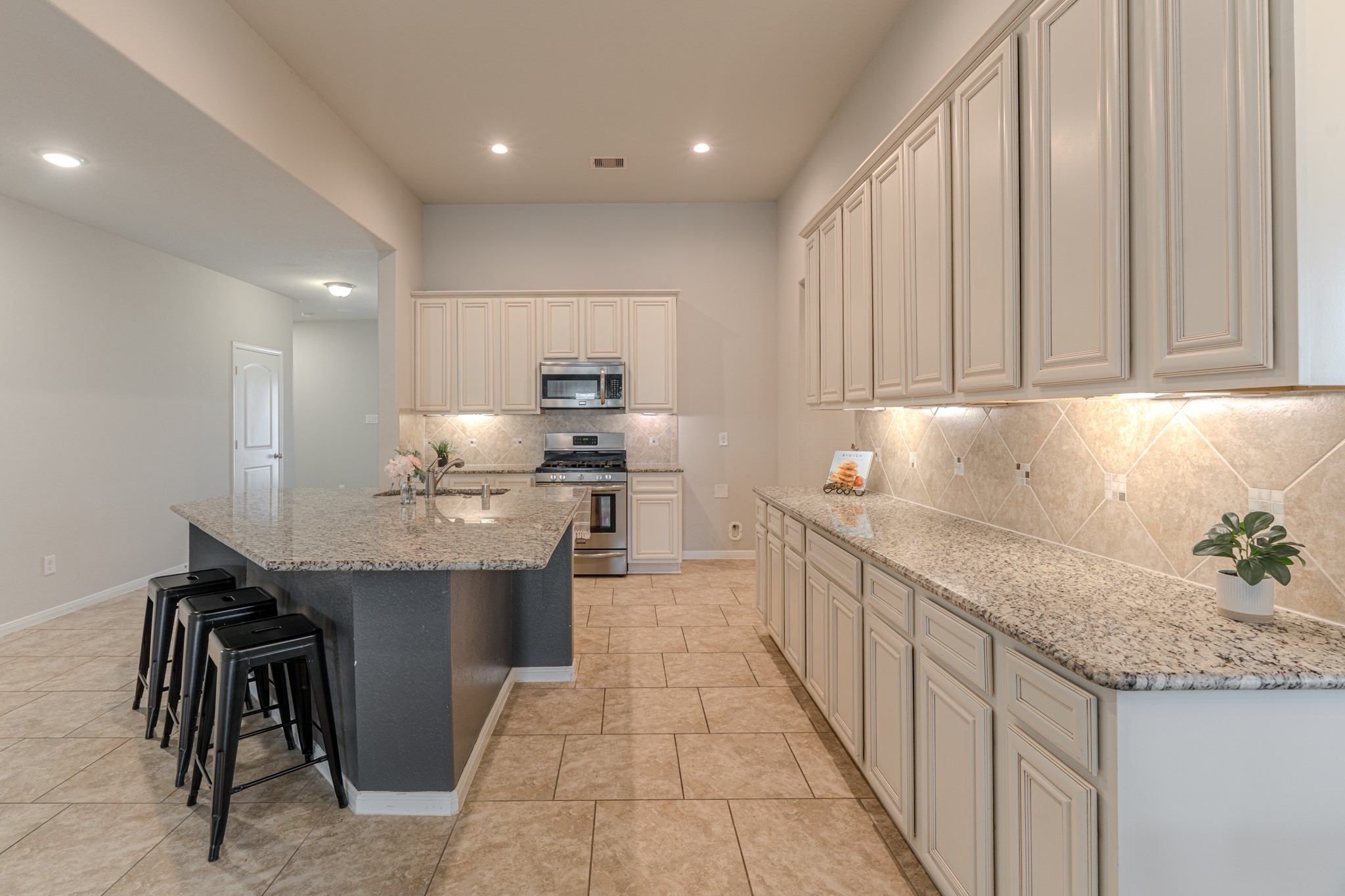 14207 Irvine Rnch Trail Conroe, TX 77384 - Photo 7 of 29 a kitchen with stainless steel appliances granite countertop a sink stove and cabinets