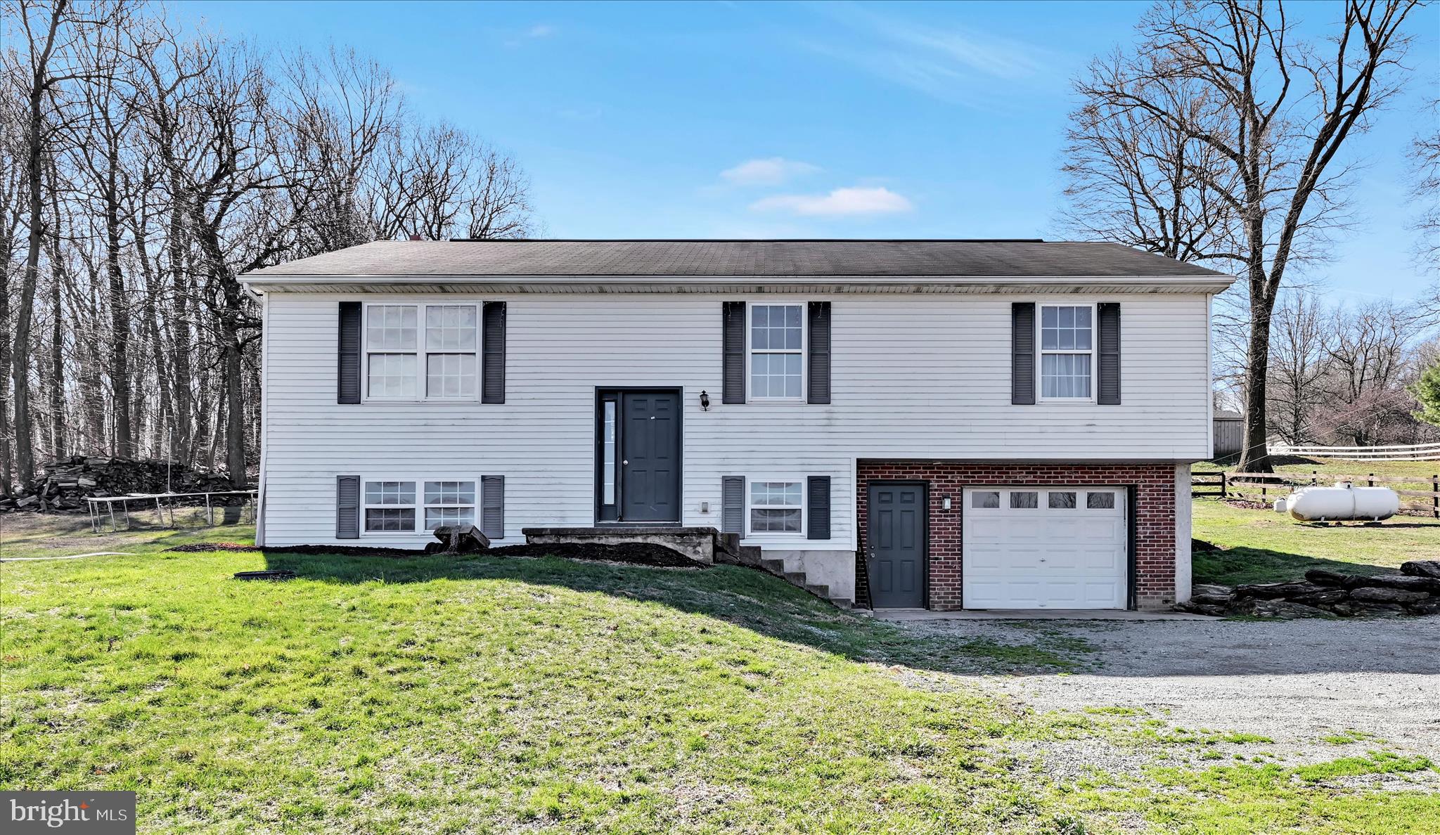 411 Red Hill Road Pequea, PA 17565 - Photo 12 of 50 a front view of a house with a yard and garage