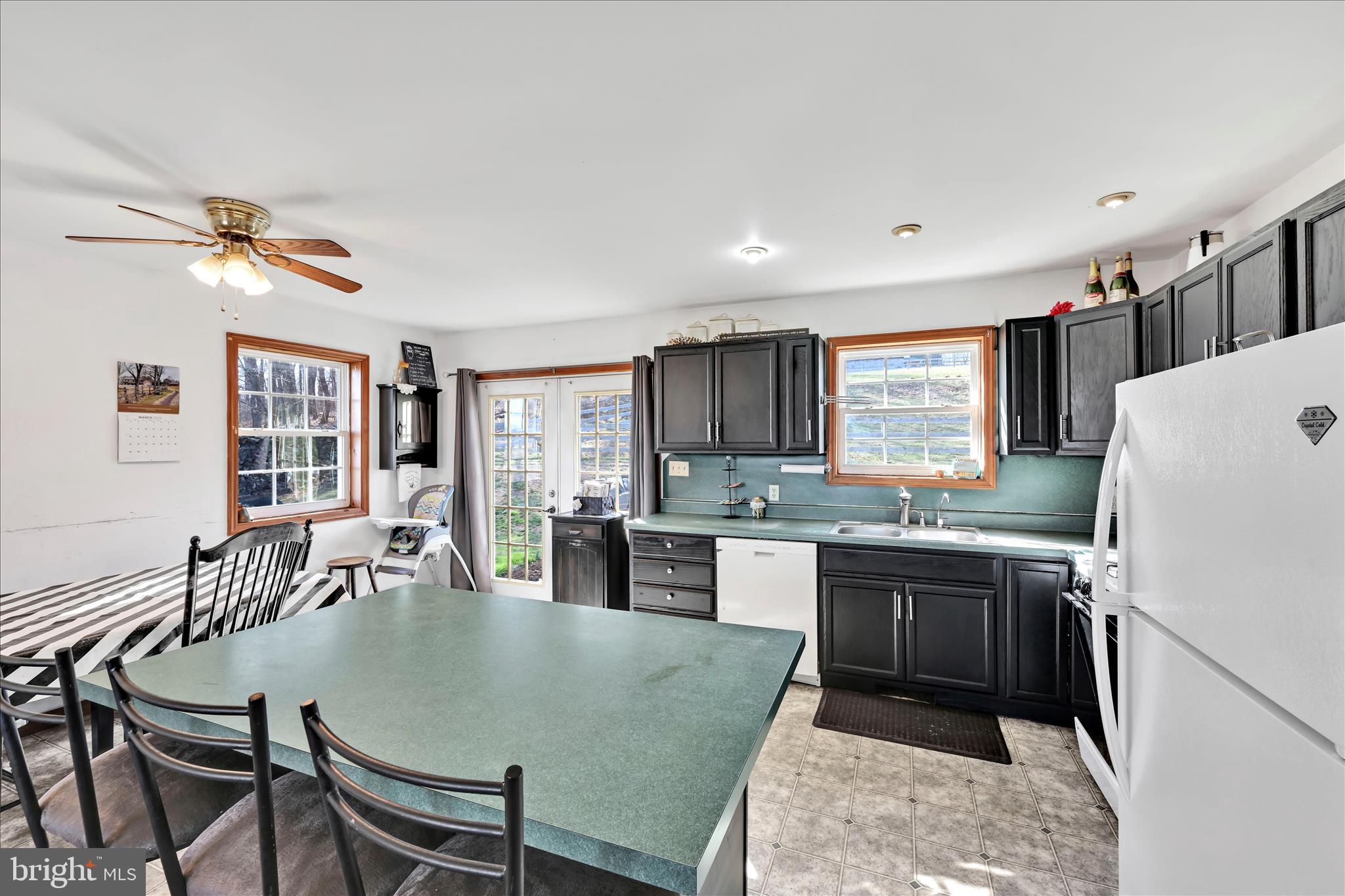 411 Red Hill Road Pequea, PA 17565 - Photo 17 of 50 a kitchen with a table chairs sink and refrigerator