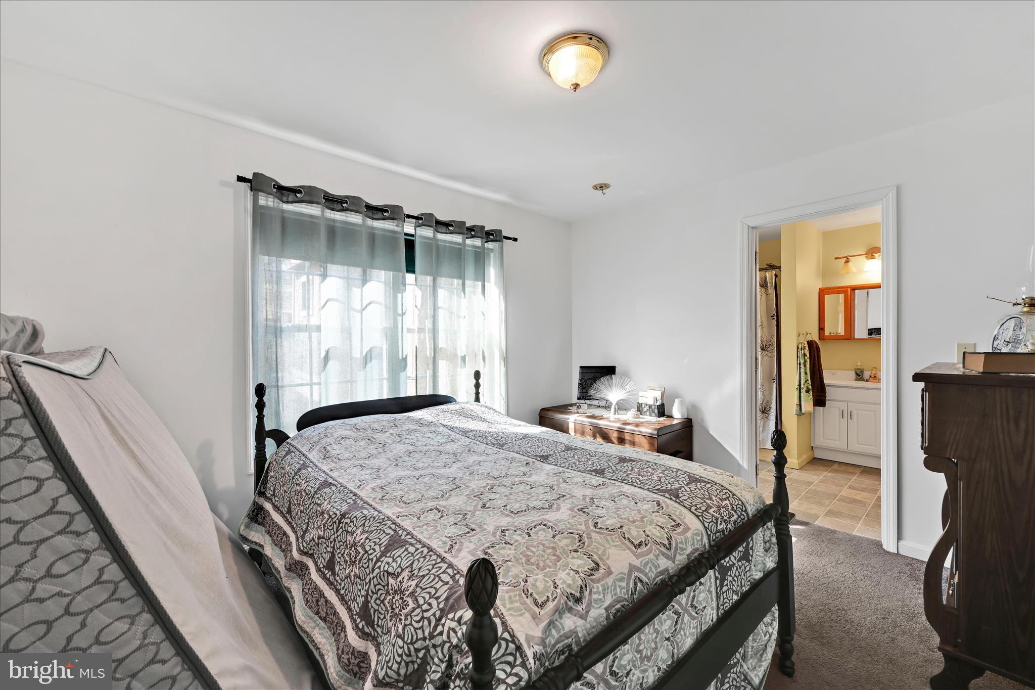 411 Red Hill Road Pequea, PA 17565 - Photo 24 of 50 a bedroom with a bed and large window