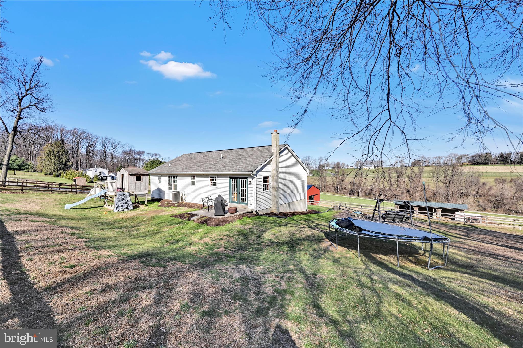 411 Red Hill Road Pequea, PA 17565 - Photo 32 of 50 a backyard of a house with barbeque oven table and chairs