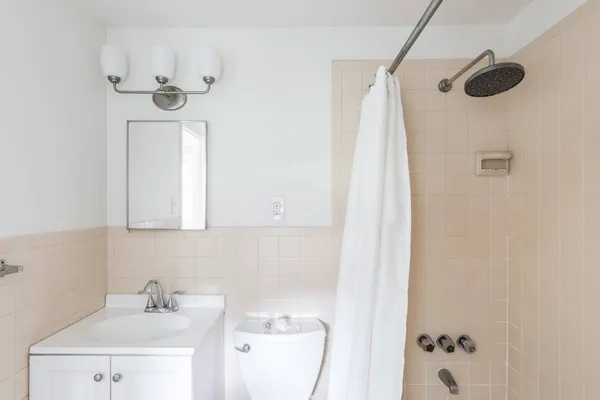 a bathroom with a sink a mirror and shower