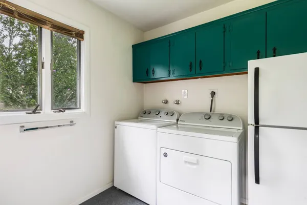 a utility room with a sink washer and dryer
