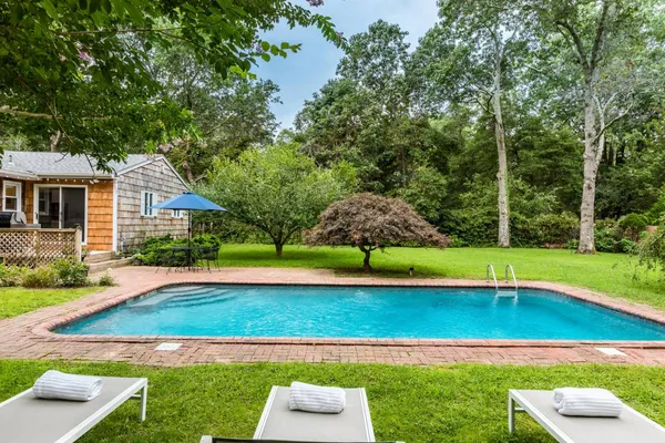 a view of a house with swimming pool and yard