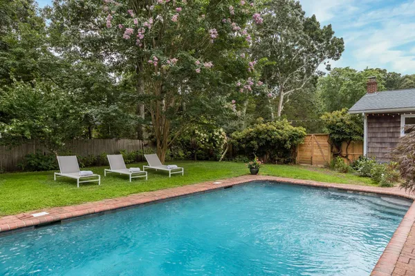 a view of a swimming pool with a yard