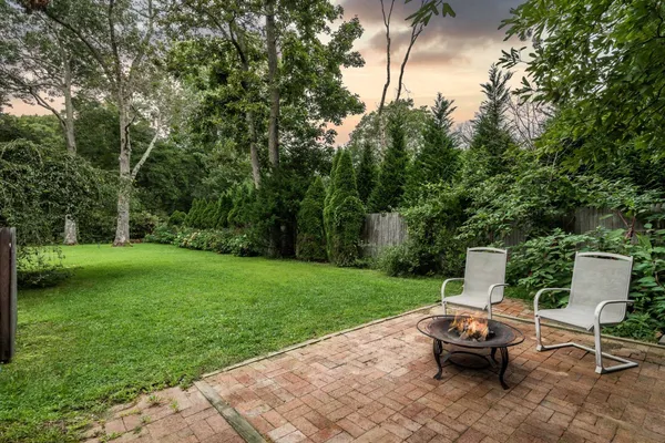 a view of a backyard with sitting area