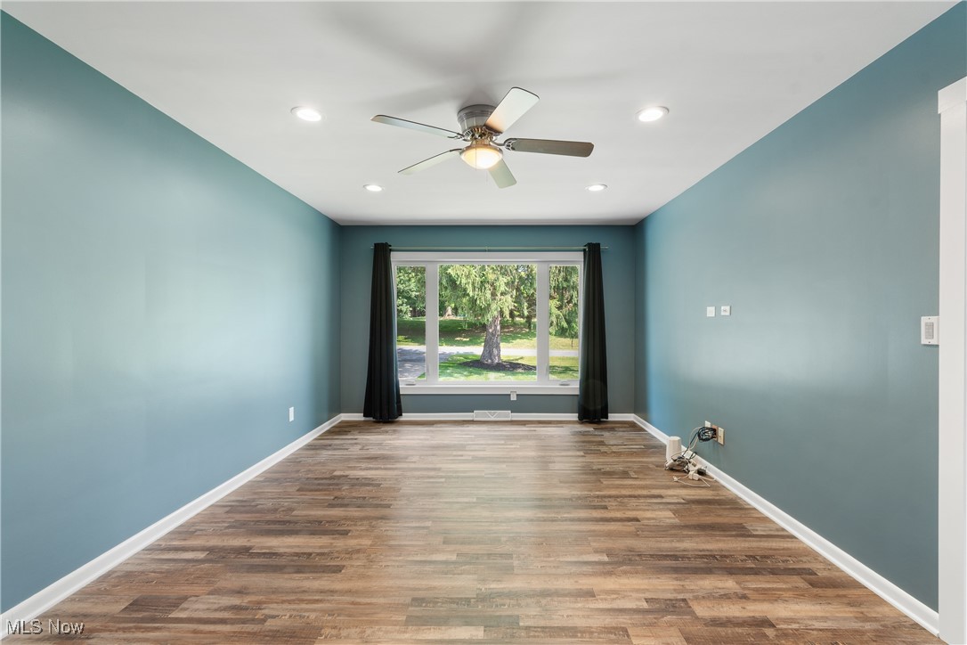 1892 Toepfer Road Akron, OH 44312 - Photo 5 of 34 Empty room with a ceiling fan, wood finished floors, baseboards, and recessed lighting