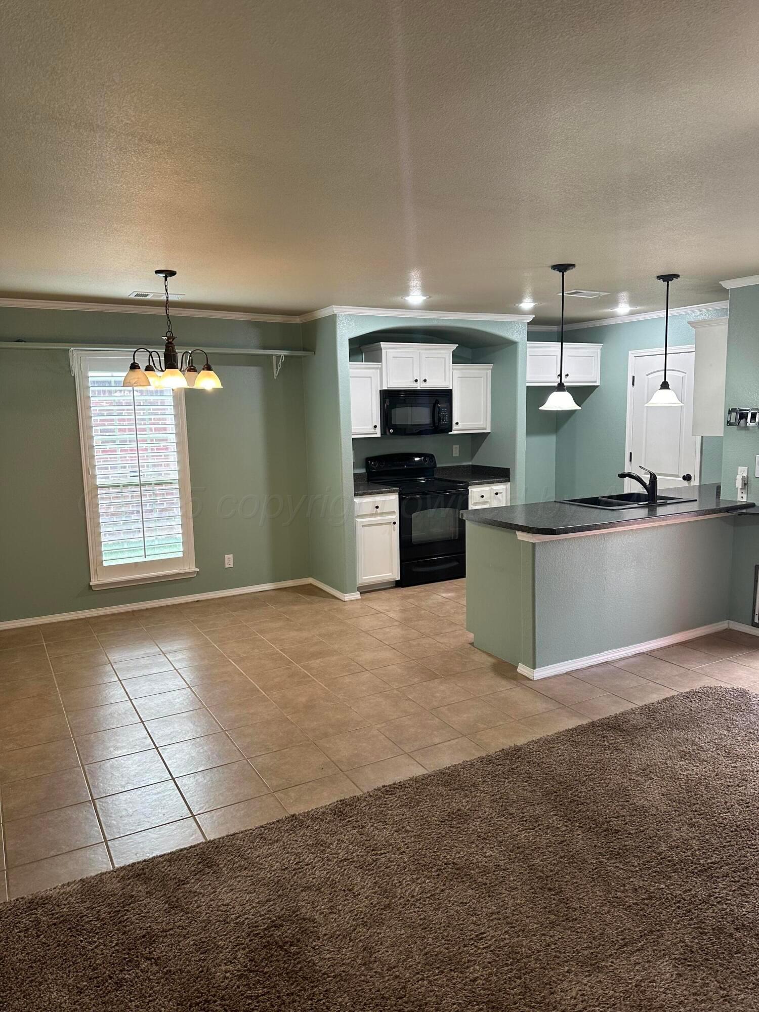 4514 South Wilson Street Amarillo, TX 79118 - Photo 2 of 5 a kitchen with stainless steel appliances granite countertop a sink and a stove top oven