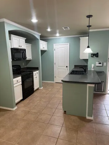 a kitchen with stainless steel appliances granite countertop a sink and a stove