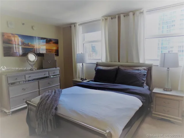 a bedroom with a bed and with furniture