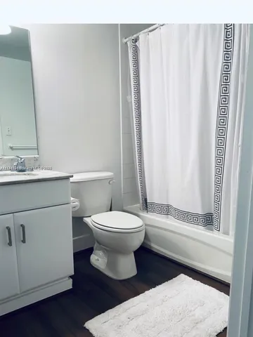 a bathroom with a toilet a sink and a mirror