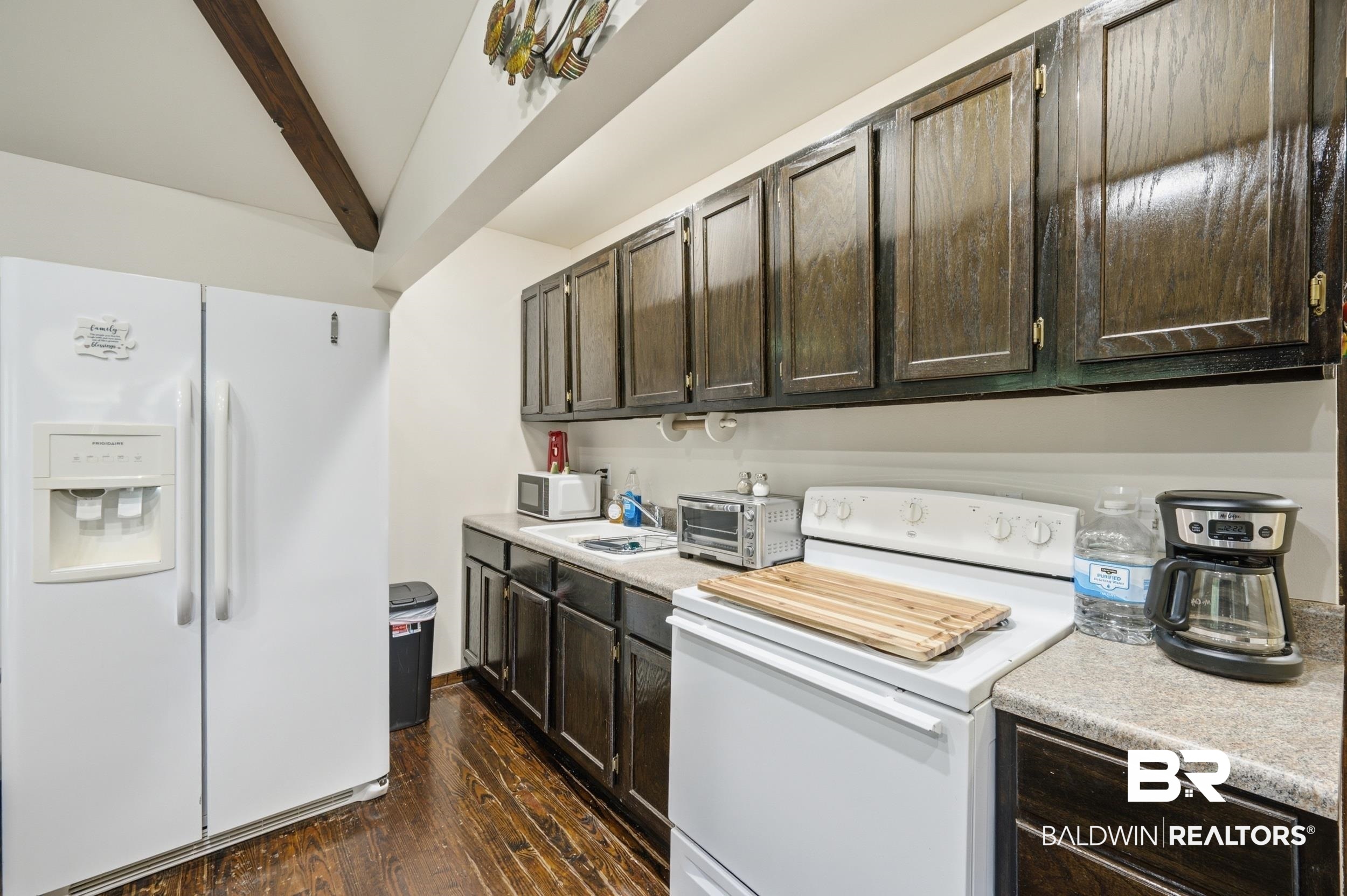 42080 Bayou Road Bay Minette, AL 36507 - Photo 24 of 43 Kitchen featuring a white side-by-side refrigerator, white electric range, wood-finish flooring, dark wood-finish cabinetry, and a single basin sink