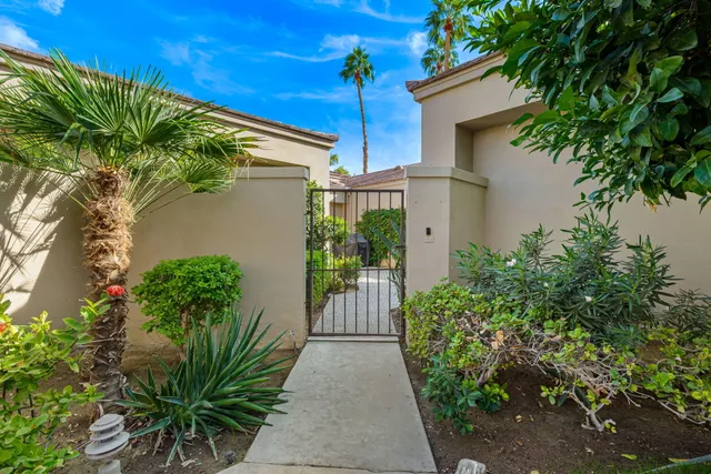 a backyard of a house with flower plants