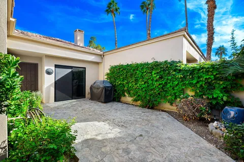 a view of a house with potted plants