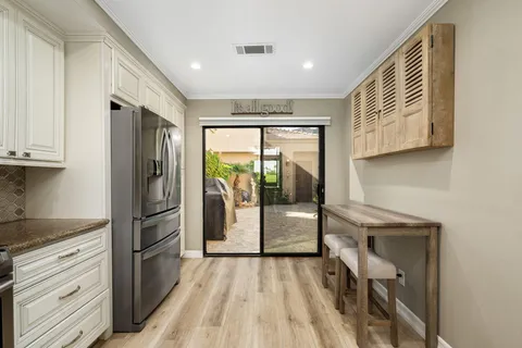 a kitchen with a refrigerator a sink and cabinets