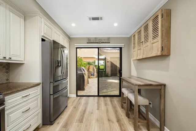 a kitchen with a refrigerator a sink and cabinets