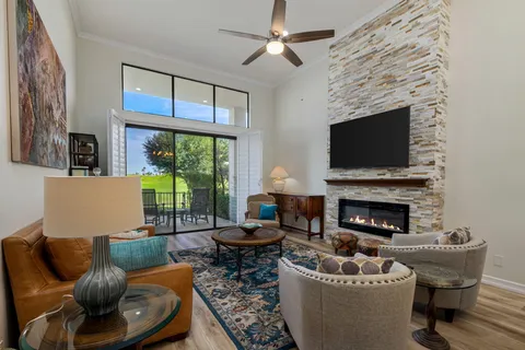 a living room with furniture a fireplace and a flat screen tv