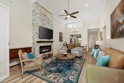 a living room with furniture a fireplace and a flat screen tv