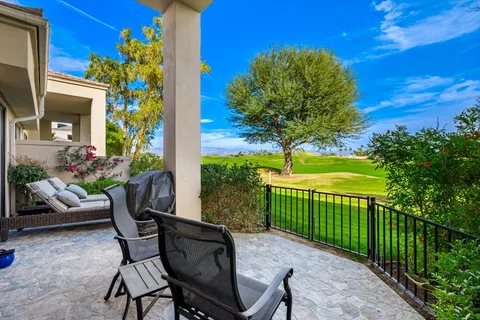 a view of a chairs and table in the back yard