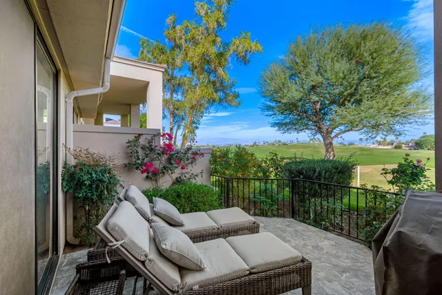 a view of a chairs and table in the balcony