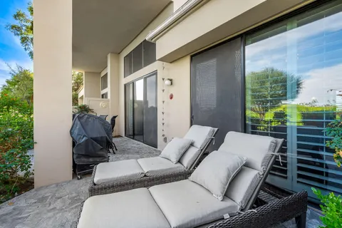 a balcony with furniture and a potted plant