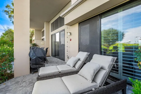 a balcony with furniture and a potted plant