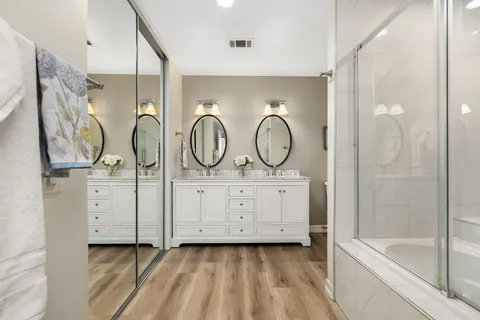 a bathroom with a tub shower and sink