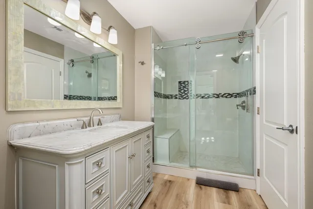 a bathroom with a granite countertop sink and a mirror