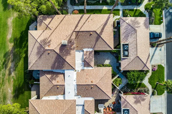 an aerial view of a house with a yard and potted plants